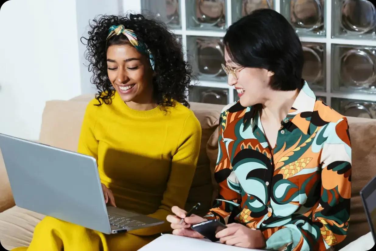 Two women looking at a laptop together