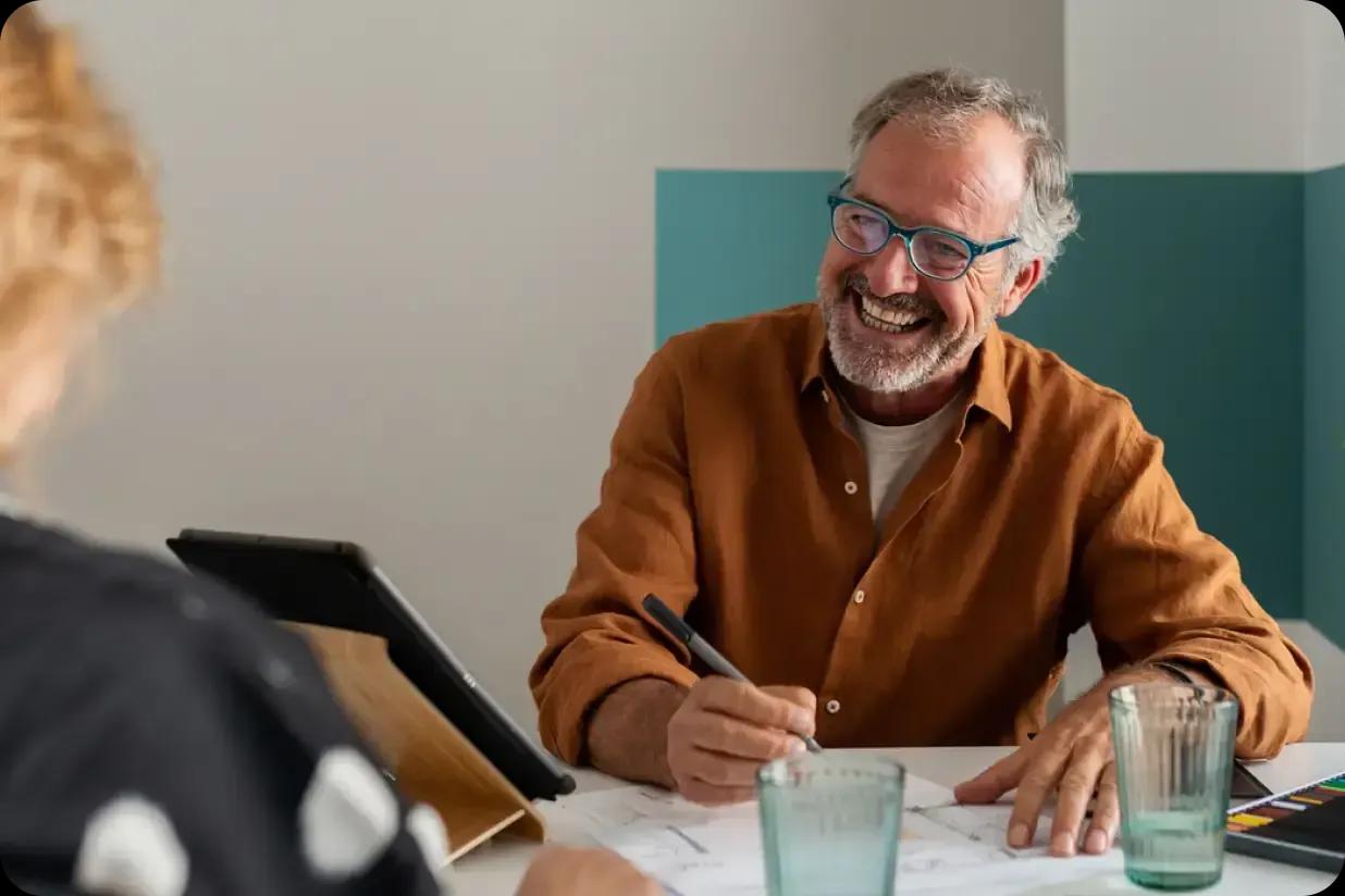 A man writing notes in a client meeting